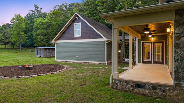 exterior space with a patio, ceiling fan, and a yard