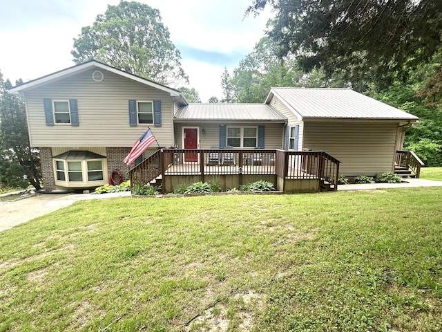 split level home with brick siding, a front lawn, and metal roof