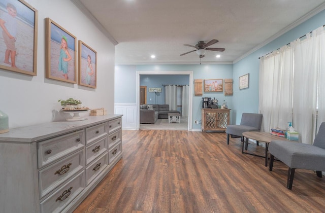 sitting room with ceiling fan, ornamental molding, a wainscoted wall, recessed lighting, and dark wood-style floors