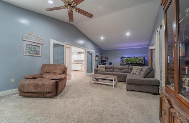 carpeted living area featuring baseboards, ceiling fan, recessed lighting, and lofted ceiling