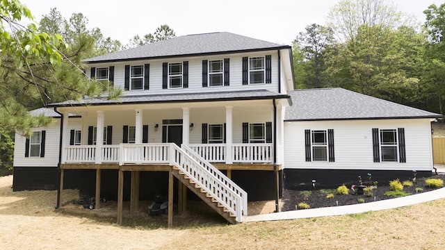 view of front of home with roof with shingles, a porch, and stairway