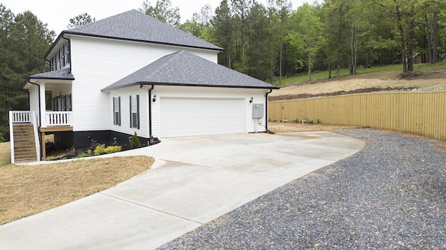 view of property exterior with a garage, a shingled roof, driveway, and stairway