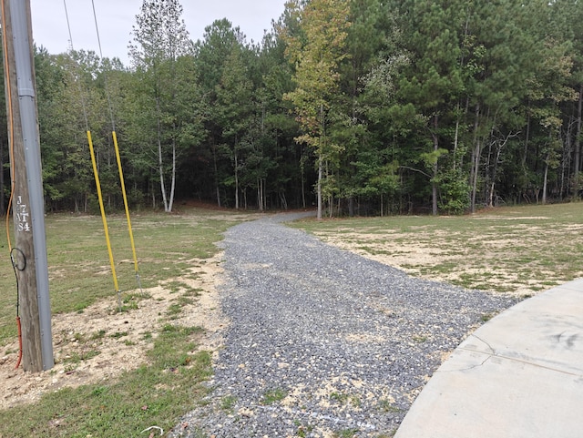 view of street featuring a wooded view