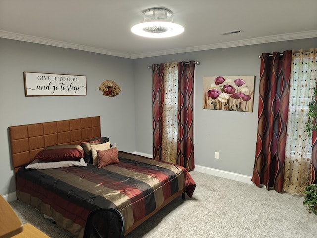 carpeted bedroom featuring crown molding, baseboards, and visible vents