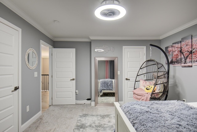 bedroom featuring crown molding, baseboards, and light carpet
