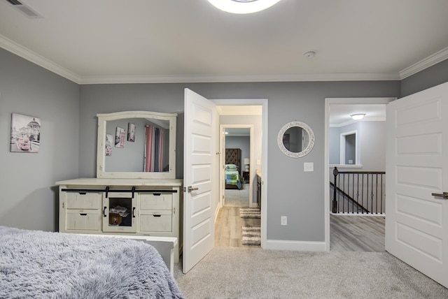 bedroom featuring baseboards, ornamental molding, carpet, and visible vents