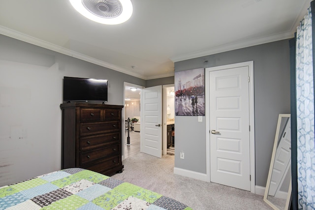 bedroom with baseboards, ornamental molding, connected bathroom, and light colored carpet