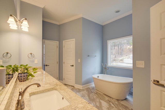 full bath featuring a sink, marble finish floor, a notable chandelier, ornamental molding, and a soaking tub