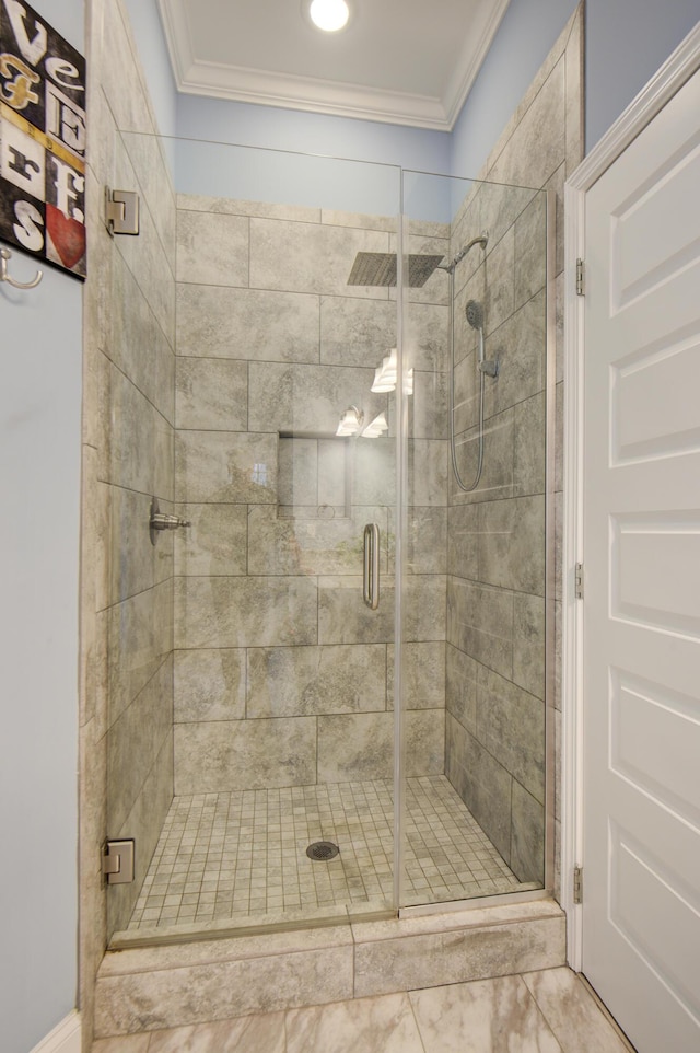 bathroom featuring ornamental molding and a shower stall