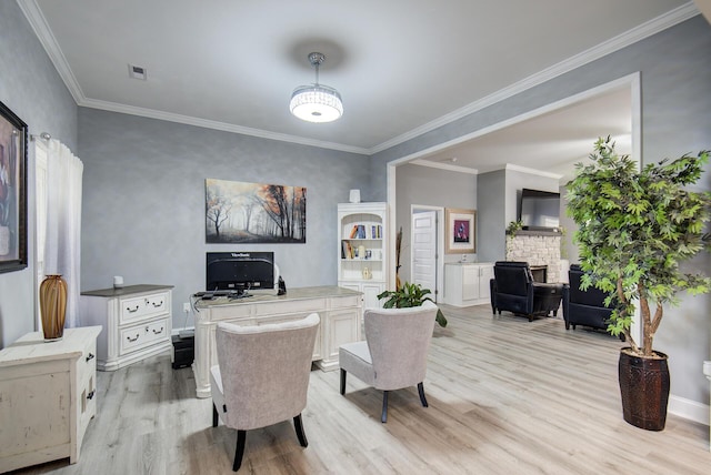 interior space with light wood-type flooring, baseboards, and crown molding