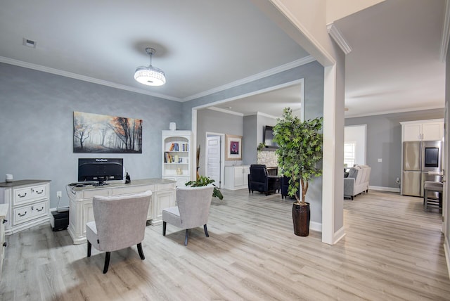 office with crown molding, baseboards, visible vents, and light wood finished floors