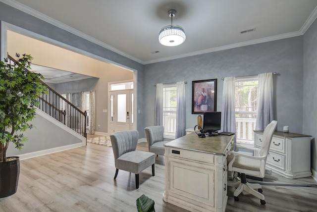 home office featuring baseboards, visible vents, ornamental molding, and light wood finished floors