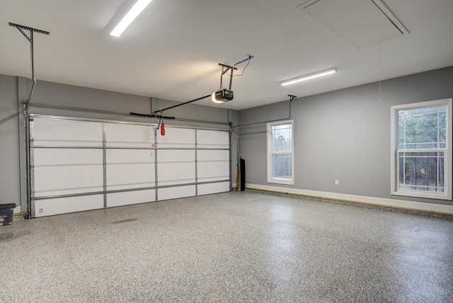 garage with baseboards and a garage door opener