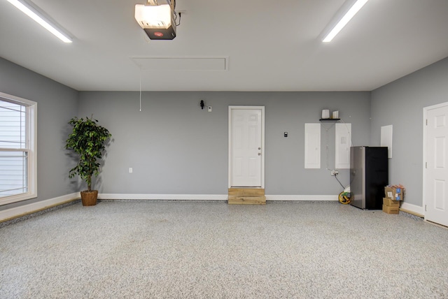 garage with baseboards and a garage door opener