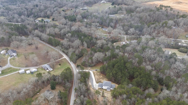 birds eye view of property featuring a forest view