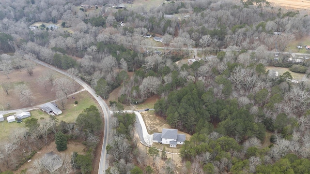 birds eye view of property with a view of trees