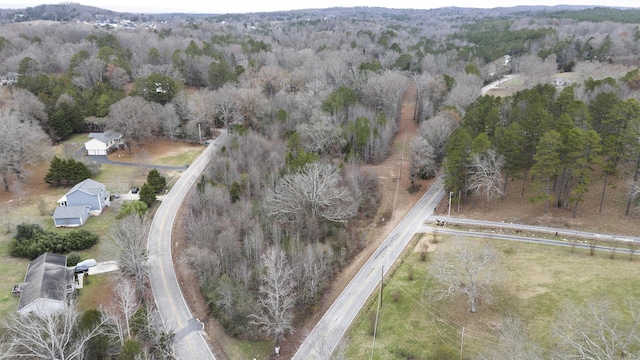 drone / aerial view featuring a wooded view