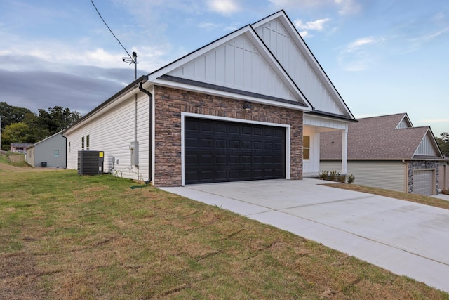 view of front of property featuring a front lawn, stone siding, board and batten siding, concrete driveway, and central air condition unit