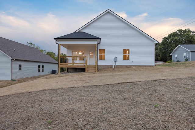 back of house at dusk with central air condition unit