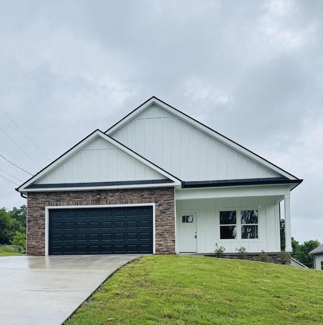 view of front facade featuring an attached garage, a front lawn, stone siding, board and batten siding, and driveway