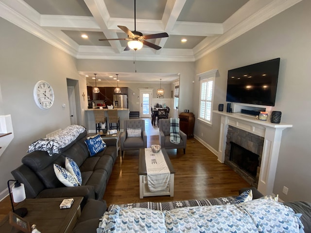 living area featuring ceiling fan, coffered ceiling, wood finished floors, and ornamental molding