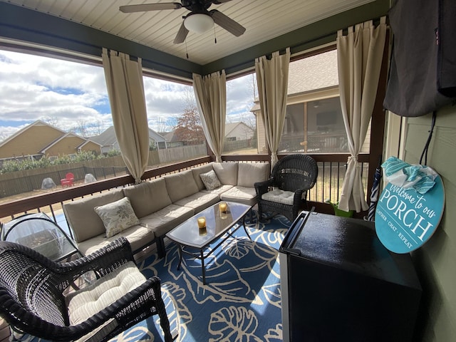 sunroom with outdoor lounge area and a ceiling fan