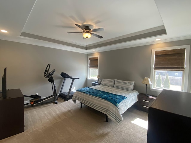 bedroom featuring a tray ceiling, ornamental molding, carpet floors, and recessed lighting