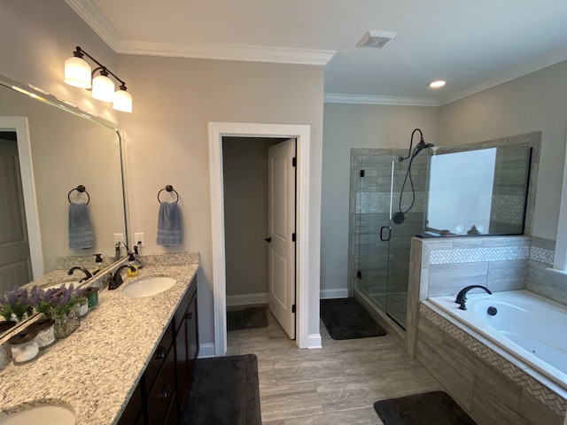 full bath featuring a sink, a bath, visible vents, a shower stall, and ornamental molding