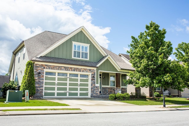 craftsman-style house featuring concrete driveway, board and batten siding, a shingled roof, and a garage