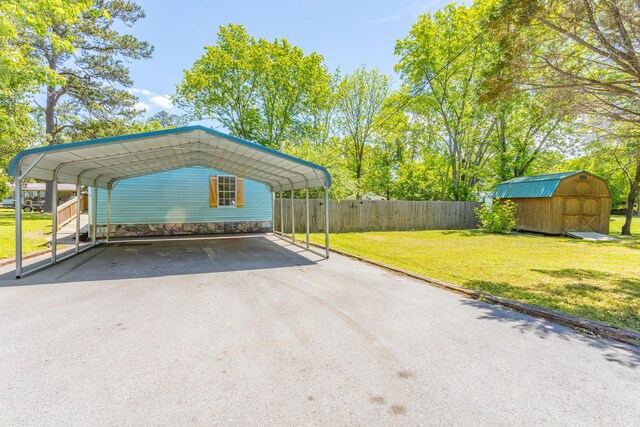229 General Thomas St, Chickamauga, GA 30707 - view of parking featuring a storage unit, driveway, and a detached carport