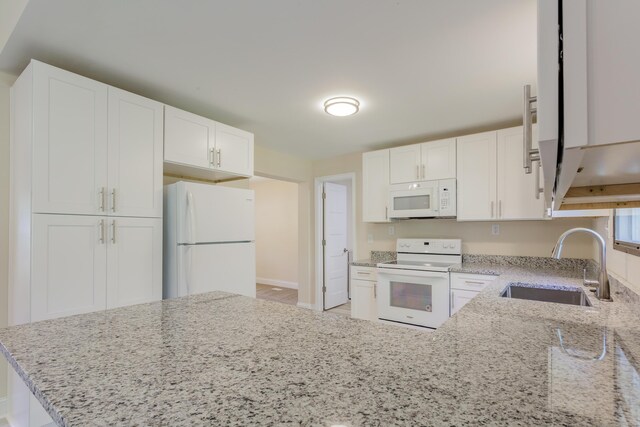 229 General Thomas St, Chickamauga, GA 30707 - kitchen with white appliances, a sink, light stone counters, and white cabinetry