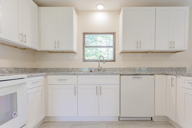 229 General Thomas St, Chickamauga, GA 30707 - kitchen featuring white dishwasher, a sink, light marble finish flooring, and white cabinets