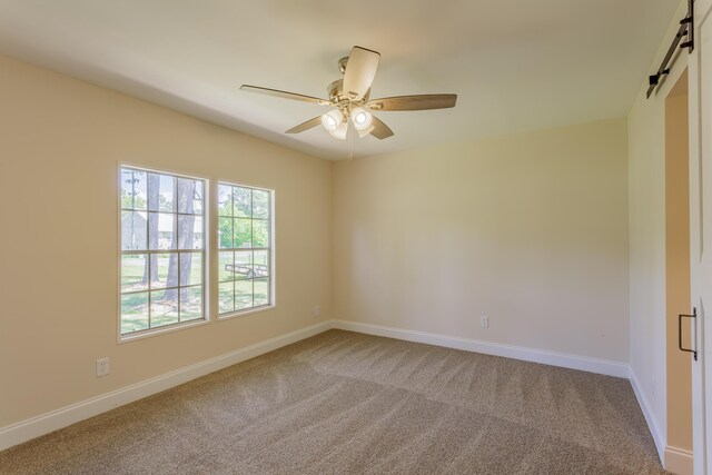 229 General Thomas St, Chickamauga, GA 30707 - carpeted empty room with a barn door, ceiling fan, and baseboards