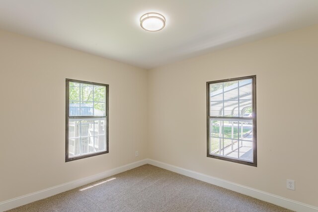 229 General Thomas St, Chickamauga, GA 30707 - empty room featuring plenty of natural light, light colored carpet, and baseboards