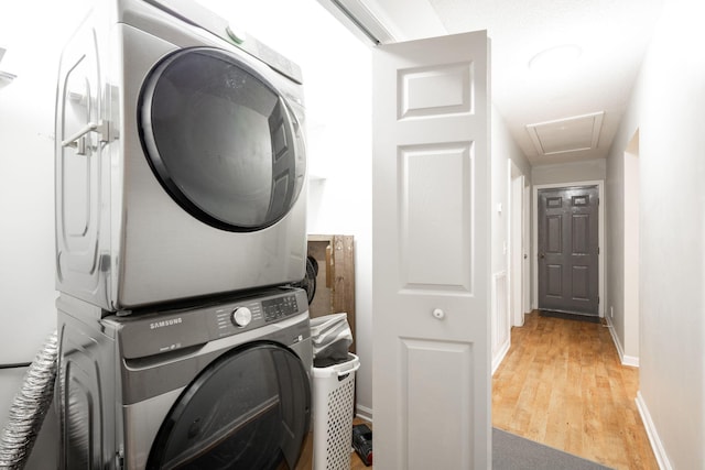 2543 W Wind Dr, Soddy Daisy, TN 37379 - washroom with stacked washer / dryer, light wood-style floors, and baseboards