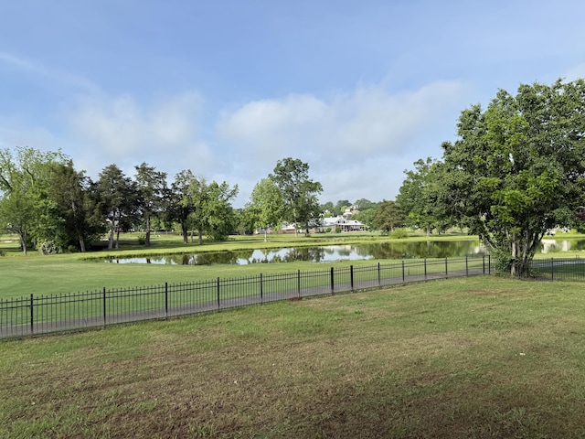 view of yard featuring a water view and fence