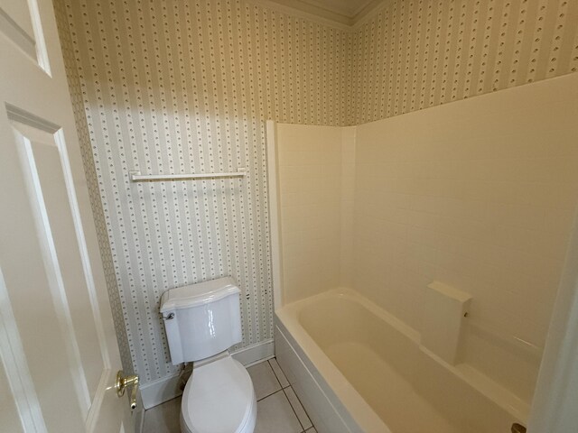 bathroom with tile patterned floors, toilet, and baseboards