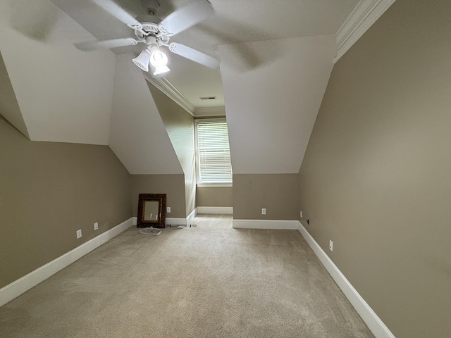 additional living space featuring light colored carpet, baseboards, a ceiling fan, and lofted ceiling