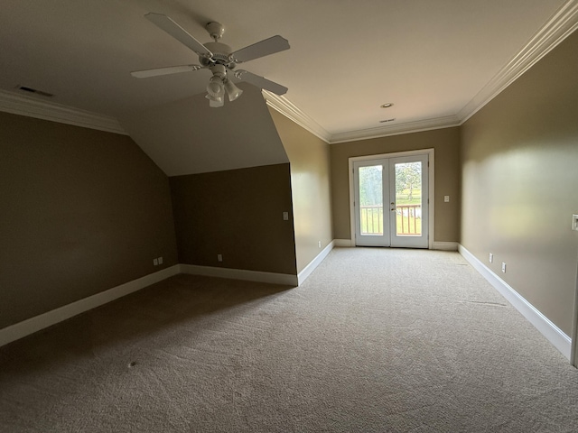 additional living space featuring light colored carpet, visible vents, vaulted ceiling, a ceiling fan, and baseboards