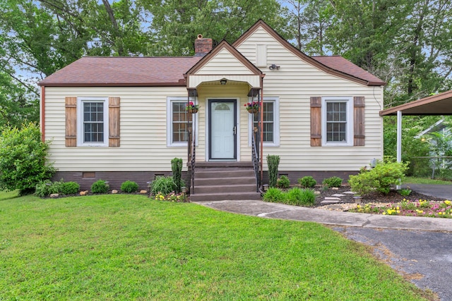 view of front facade featuring a front lawn, aphalt driveway, a chimney, a shingled roof, and crawl space