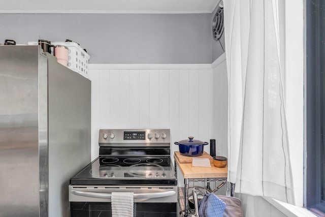 kitchen with a wainscoted wall and stainless steel appliances