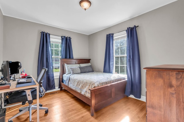bedroom featuring baseboards and wood finished floors