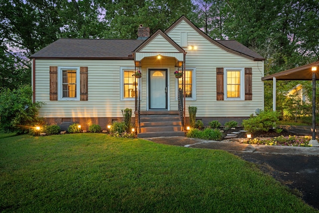 bungalow-style home featuring crawl space, a chimney, a shingled roof, and a front lawn