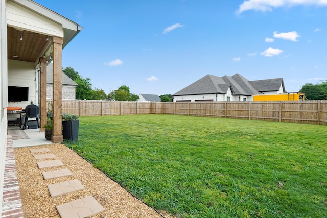 view of yard with a fenced backyard and a patio area