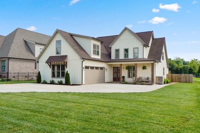 view of front of property featuring a front lawn, fence, roof with shingles, board and batten siding, and driveway