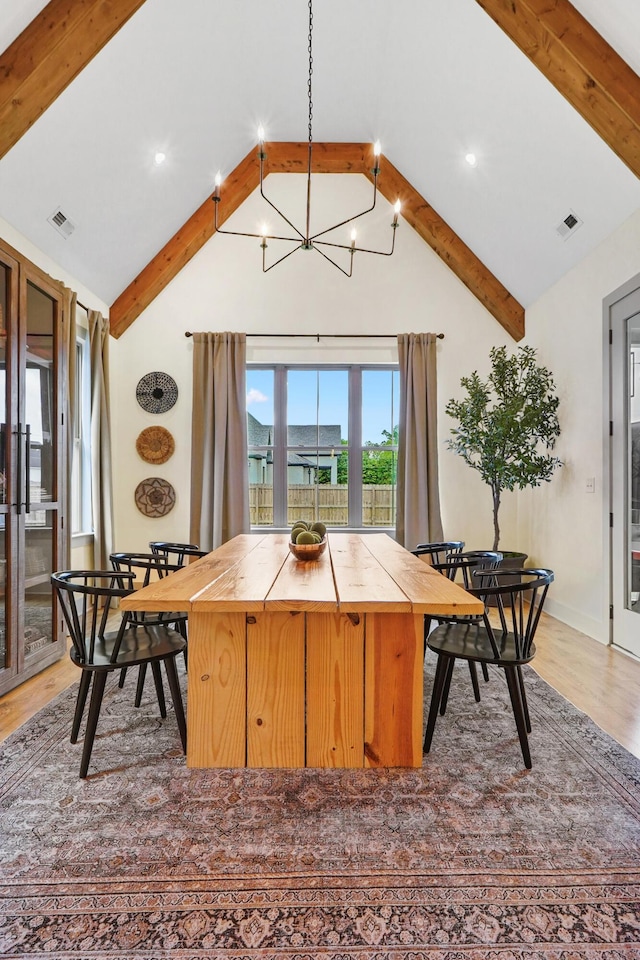 dining room with visible vents, beam ceiling, and a notable chandelier
