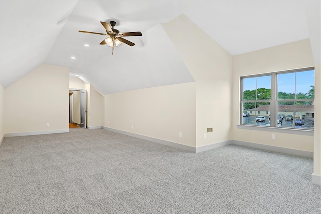 additional living space featuring baseboards, a ceiling fan, lofted ceiling, and carpet flooring