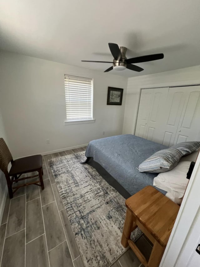 5561 River Rd, Decatur, TN 37322 - bedroom with a closet, ceiling fan, wood tiled floors, and baseboards