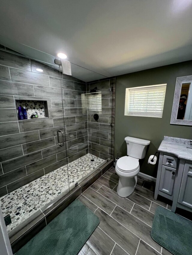 5561 River Rd, Decatur, TN 37322 - bathroom with toilet, a shower stall, vanity, baseboards, and recessed lighting