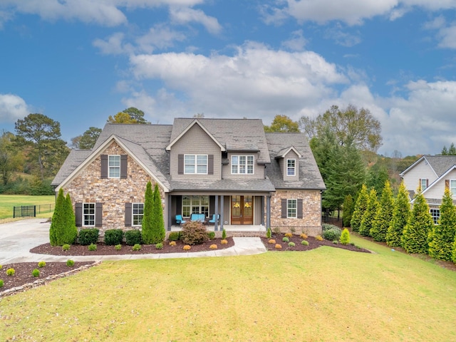 2025 Enclave Dr, Rocky Face, GA 30740 - craftsman-style home with stone siding, fence, a front yard, a porch, and roof with shingles